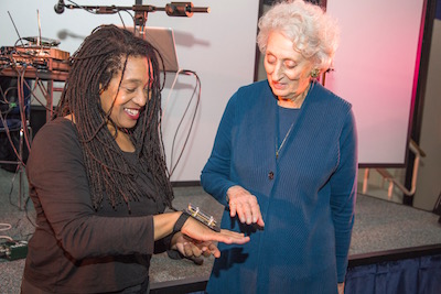 Pamela Z demonstrating one of the devices she uses to control sound using hand motions